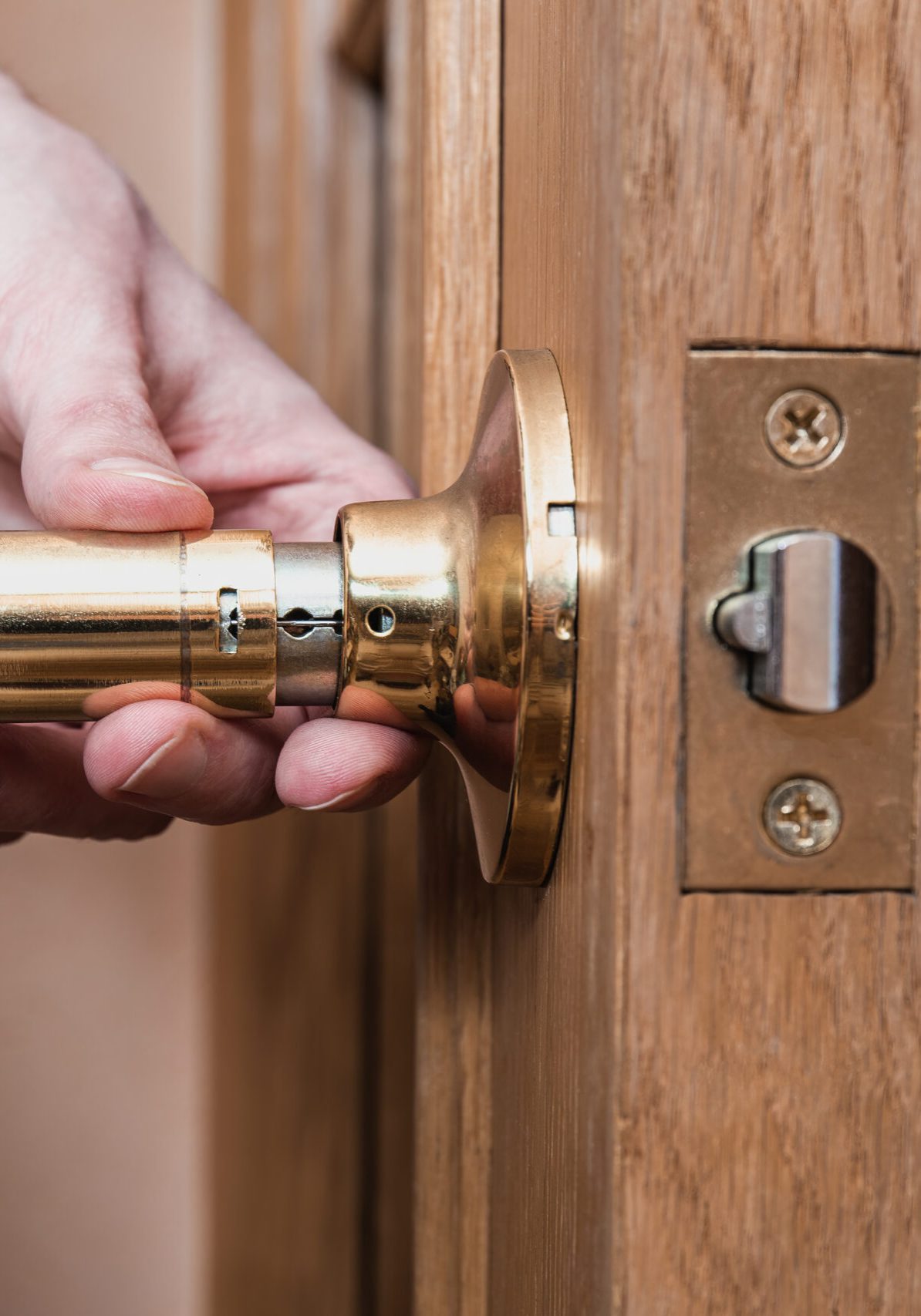 locksmith carpenter fix knob on wooden door by screwdriver for home service reparation.